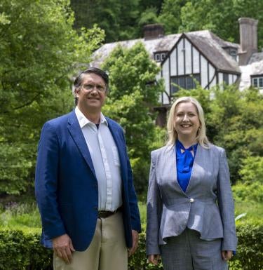 Pitt-Greensburg President Robert Gregerson and FHC dean Nicola Foote stand in front of Greensburg's Lynch Hall.