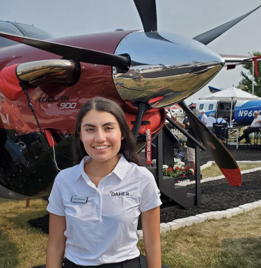 Alison Linares Mendoza stands in front of aircraft